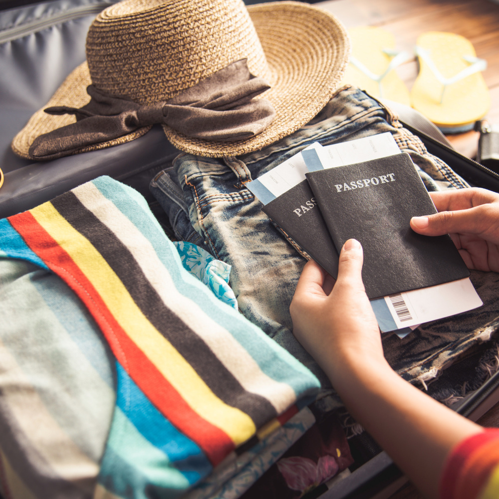Traveller Preparing For Trip with Clothes Hat and Passport in Suitcase